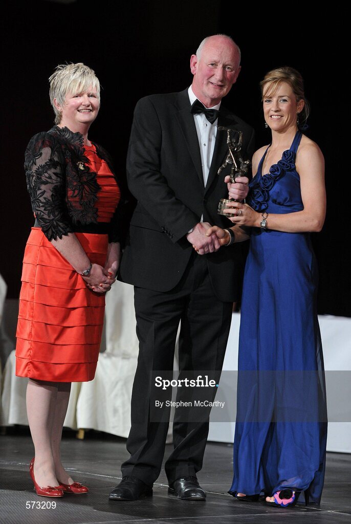 5 November 2011; Wexford's Kate Kelly is presented with her 2011 Camogie All-Star award by Brian Cody, Kilkenny hurling manager, and Joan O' Flynn, President of the Camogie Association, at the 2011 Camogie All-Stars in association with ONeills. Citywest Hotel, Saggart, Co. Dublin. Picture credit: Stephen McCarthy / SPORTSFILE