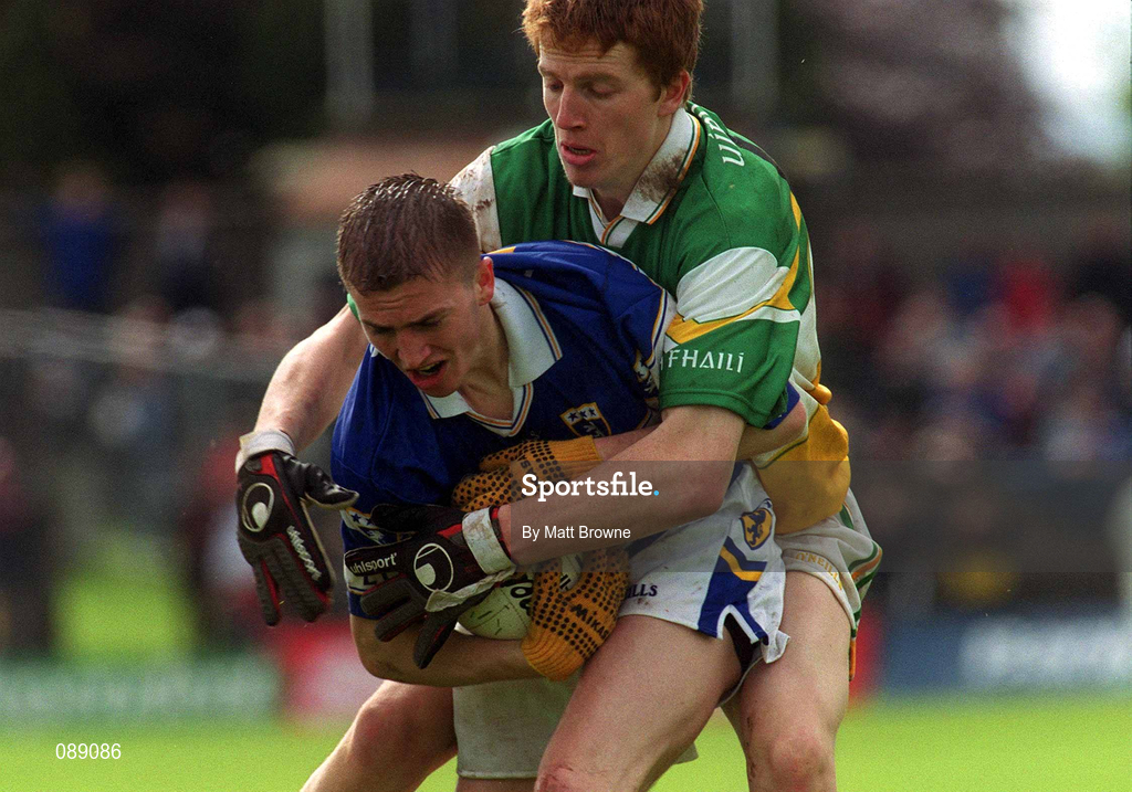 26 May 2002; Joe Higgins of Laois is tackled by Pascal Kellaghan of Offaly during the Bank of Ireland Leinster Senior Football Championship Quarter-Final match between Offaly and Laois at O'Connor Park in Tullamore, Offaly. Photo by Matt Browne/Sportsfile
