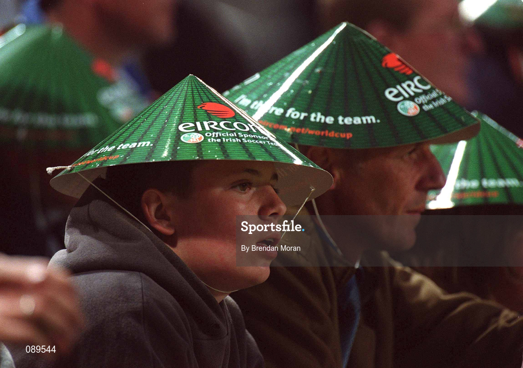16 May 2002; Republic of Ireland supporters shelter from the rain during the International Friendly match between Republic of Ireland and Nigeria at Lansdowne Road in Dublin. Photo by Brendan Moran/Sportsfile