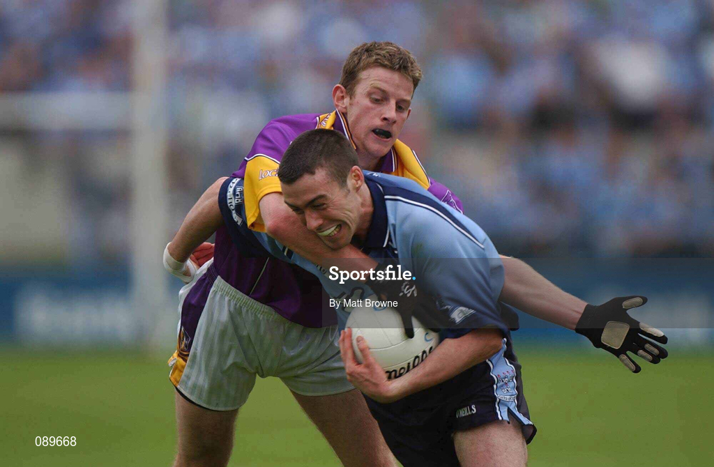 1 June 2002; Ray Cosgrove of Dublin is tackled by Wexford's Niall Murphy during the Bank of Ireland Leinster Senior Football Championship Quarter-Final match between Wexford and Dublin at Dr. Cullen Park in Carlow. Photo by Matt Browne/Sportsfile