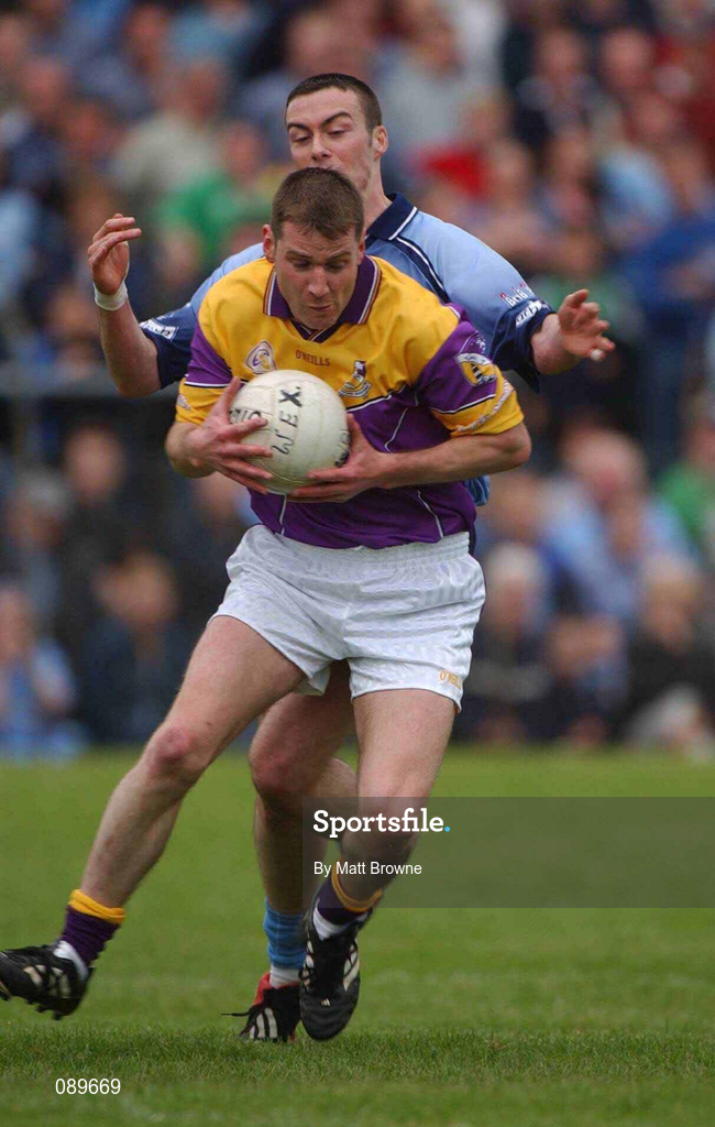 1 June 2002; Pat Forde of Wexford is tackled by Dublin's Ray Cosgrove during the Bank of Ireland Leinster Senior Football Championship Quarter-Final match between Wexford and Dublin at Dr. Cullen Park in Carlow. Photo by Matt Browne/Sportsfile