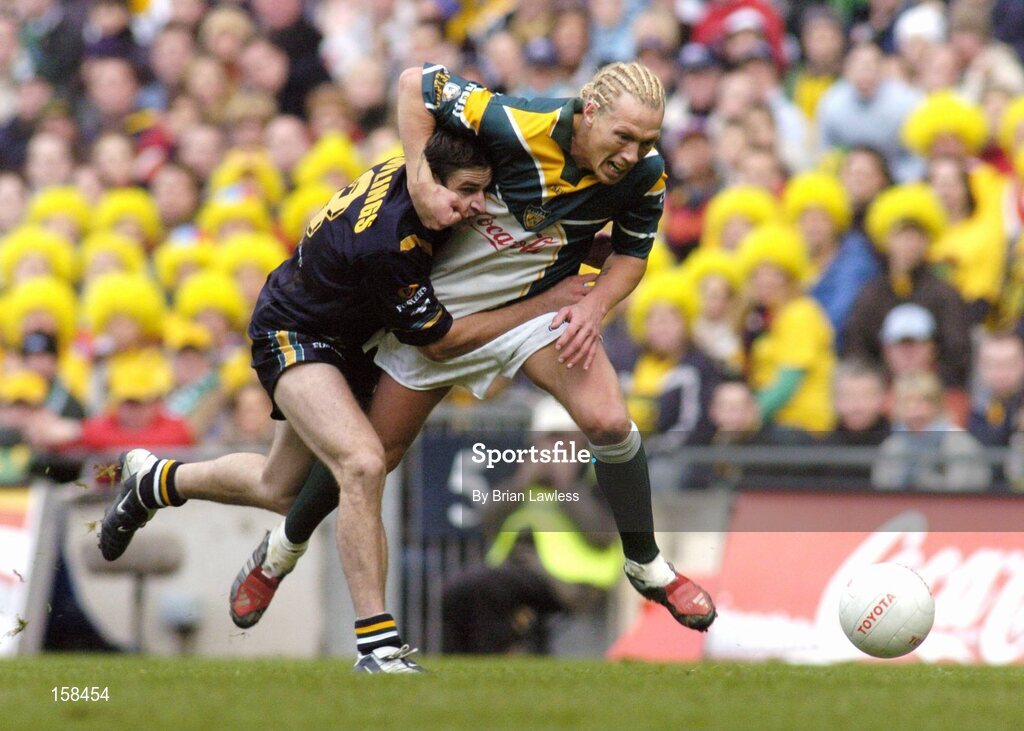 17 October 2004; Ciaran McDonald, Ireland, in action against Brady Rawlings, Australia. Coca Cola International Rules Series 2004, First Test, Ireland v Australia, Croke Park, Dublin. Picture credit; Brian Lawless / SPORTSFILE *** Local Caption *** Any photograph taken by SPORTSFILE during, or in connection with, the 2004 Coca Cola International Rules Series which displays GAA logos or contains an image or part of an image of any GAA intellectual property, or, which contains images of a GAA player/players in their playing uniforms, may only be used for editorial and non-advertising purposes.  Use of photographs for advertising, as posters or for purchase separately is strictly prohibited unless prior written approval has been obtained from the Gaelic Athletic Association.