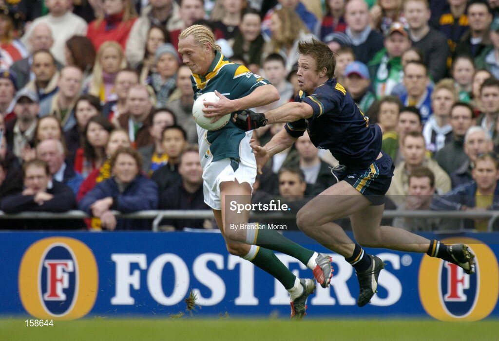 17 October 2004; Ciaran McDonald, Ireland, in action against Max Hudghton, Australia. Coca Cola International Rules Series 2004, First Test, Ireland v Australia, Croke Park, Dublin. Picture credit; Brendan Moran / SPORTSFILE *** Local Caption *** Any photograph taken by SPORTSFILE during, or in connection with, the 2004 Coca Cola International Rules Series which displays GAA logos or contains an image or part of an image of any GAA intellectual property, or, which contains images of a GAA player/players in their playing uniforms, may only be used for editorial and non-advertising purposes.  Use of photographs for advertising, as posters or for purchase separately is strictly prohibited unless prior written approval has been obtained from the Gaelic Athletic Association.