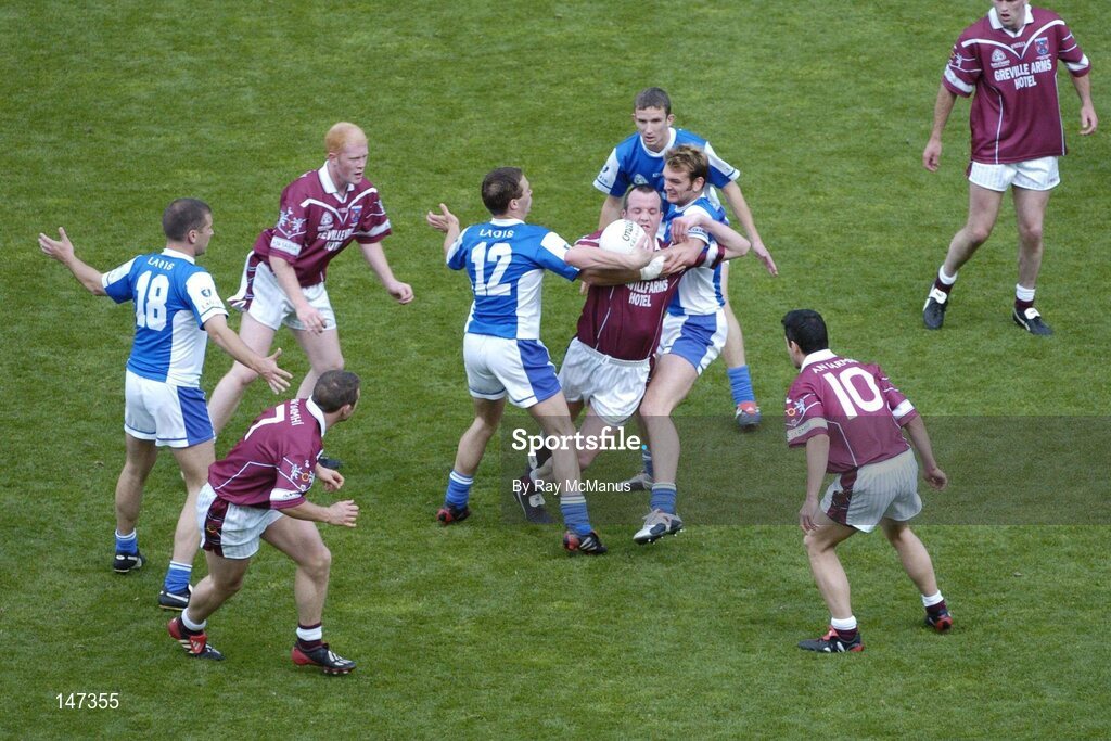 18 July 2004; Rory O'Connell, Westmeath, is tackled by Chris Conway, 12 and Noel Garvan, Laois. Bank of Ireland Leinster Senior Football Championship Final, Laois v Westmeath, Croke Park, Dublin. Picture credit; Ray McManus / SPORTSFILE