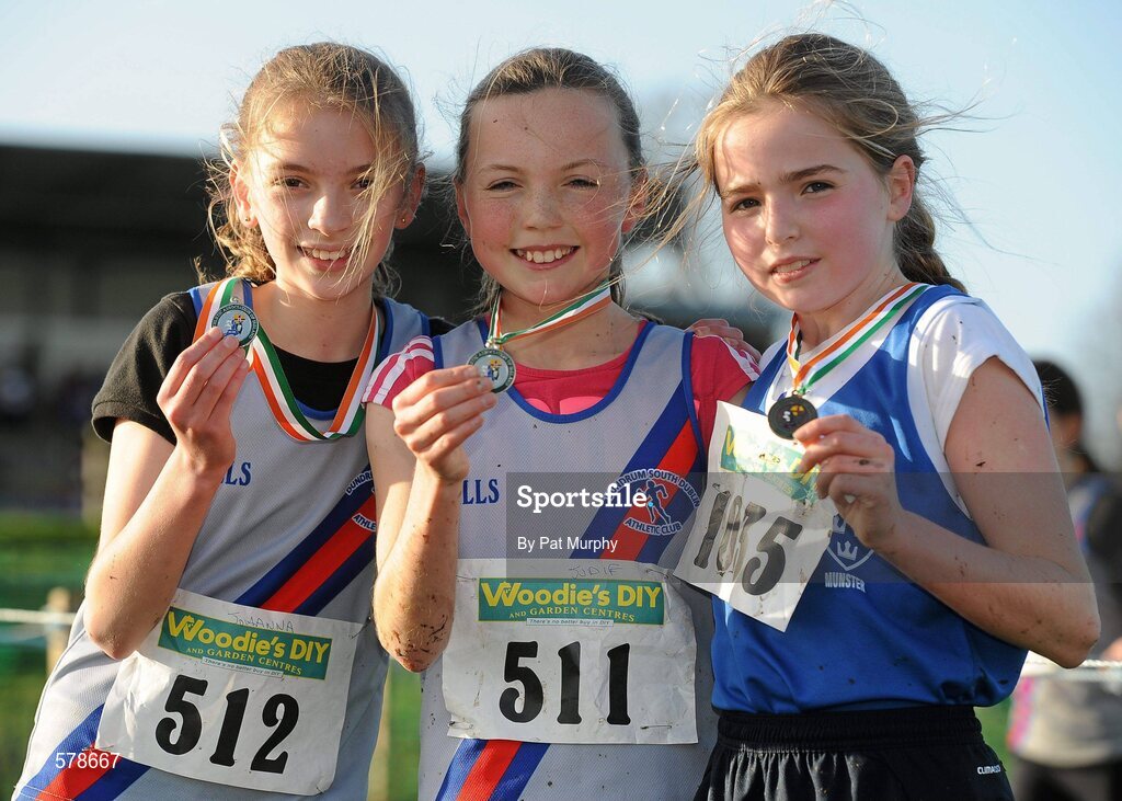 27 November 2011; Jodie McCann, Dundrum South Dublin AC, winner of the Girl's U12 race during the Woodie’s DIY Inter County Cross Country Championships with second placed Johanna McCambridge, Dundrum South Dublin AC, left, and third placed Shona O'Brien, Munster, right. Sligo Racecourse, Sligo. Picture credit: Pat Murphy / SPORTSFILE