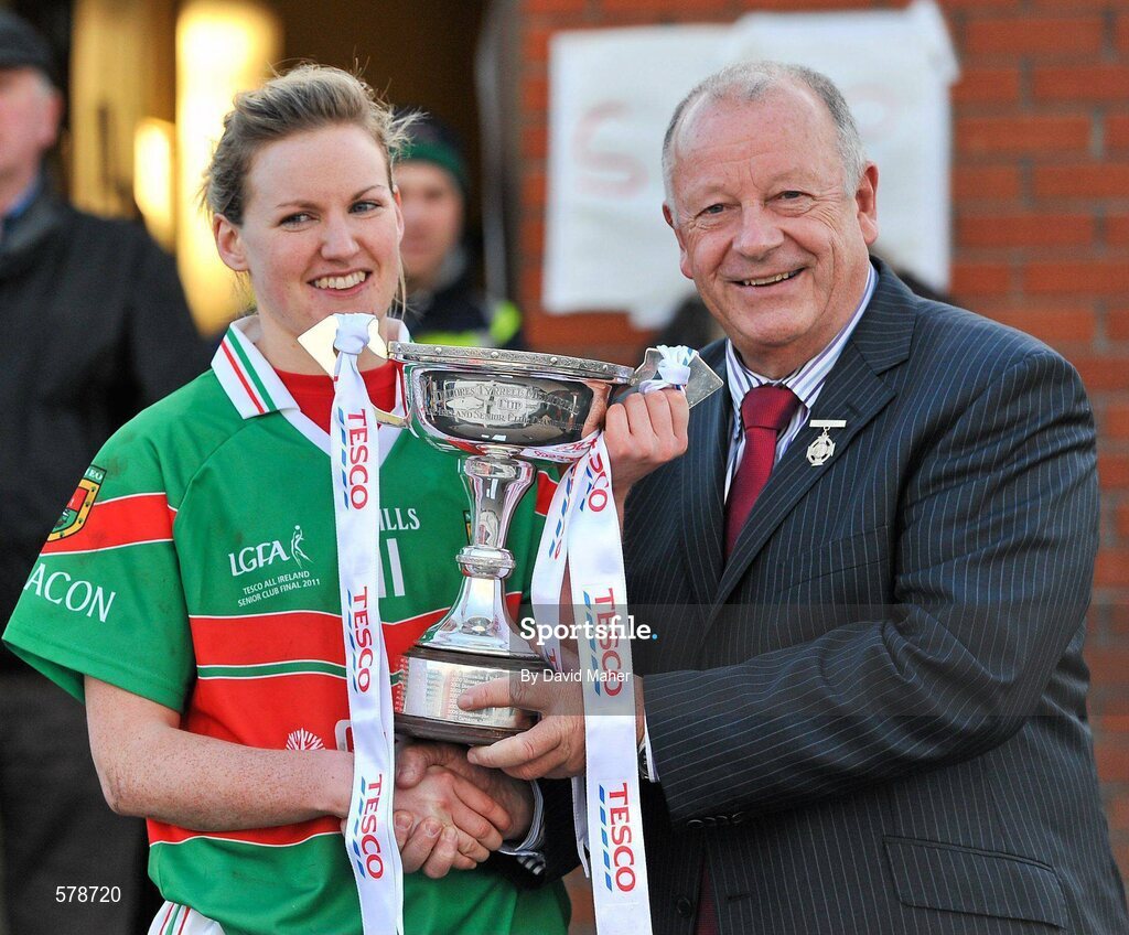 27 November 2011; Pat Quill, President of the Ladies Gaelic Football Association, presents the Dolores Tyrrell Memorial Cup to Carnacon captain Fiona McHale. Tesco All-Ireland Senior Ladies Football Club Championship Final, Carnacon v Na Fianna, Ballymahon, Co. Longford. Picture credit: David Maher / SPORTSFILE