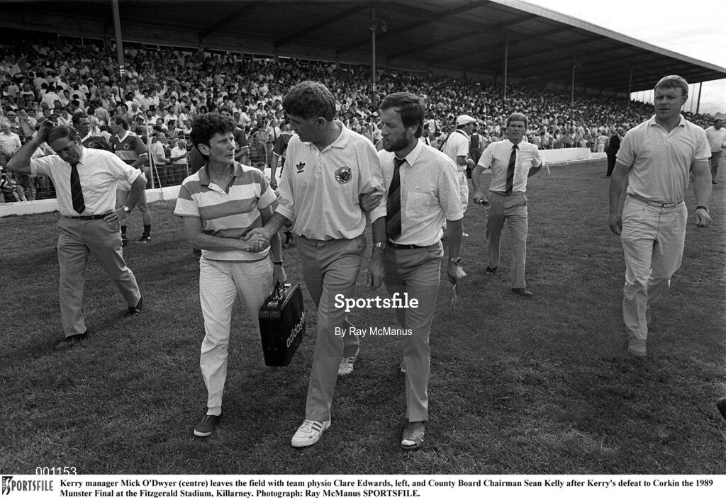 23 July 1989; Kerry manager Mick O'Dwyer (centre) leaves the field with team physio Clare Edwards, left, and County Board Chairman Sean Kelly after Kerry's defeat to Cork in the 1989 Munster Final at the Fitzgerald Stadium, Killarney. Photograph: Ray McManus SPORTSFILE.