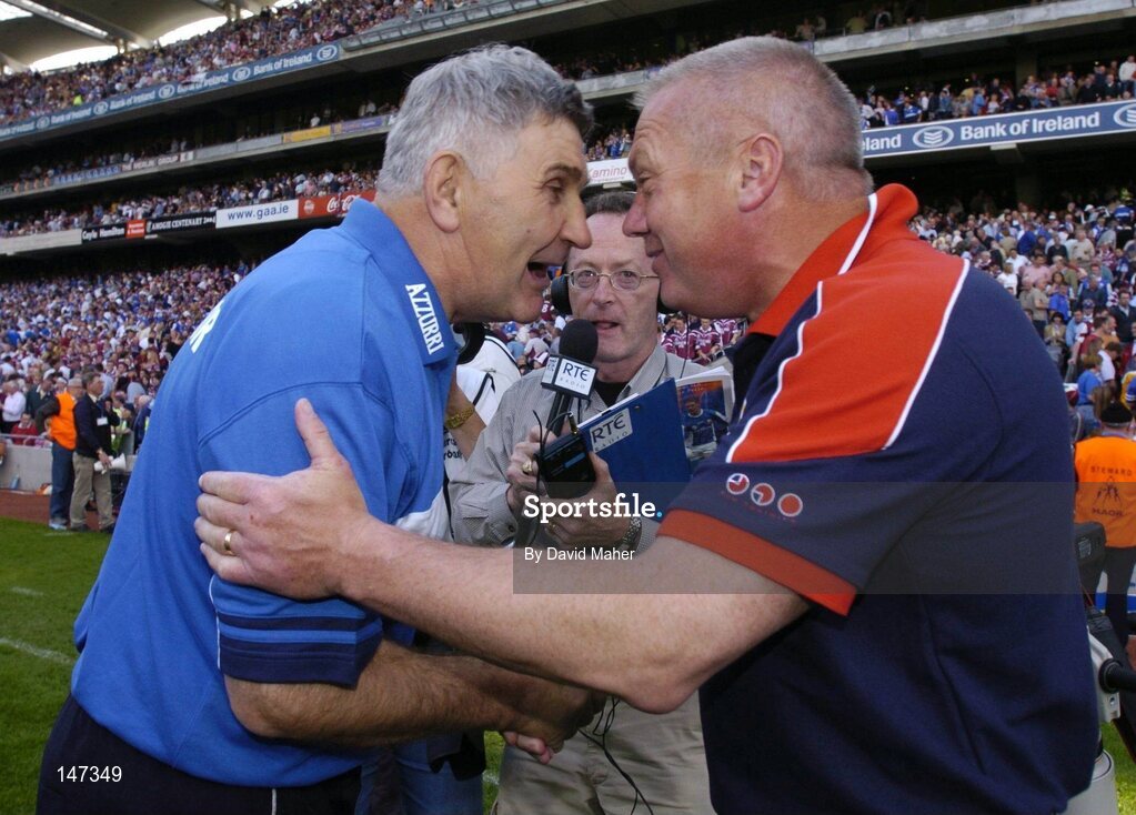 18 July 2004; Paidi O'Se, right, Westmeath manager, shakes hands with Laois manager Mick O'Dwyer at the end of the game. Bank of Ireland Leinster Senior Football Championship Final, Laois v Westmeath, Croke Park, Dublin. Picture credit; David Maher / SPORTSFILE