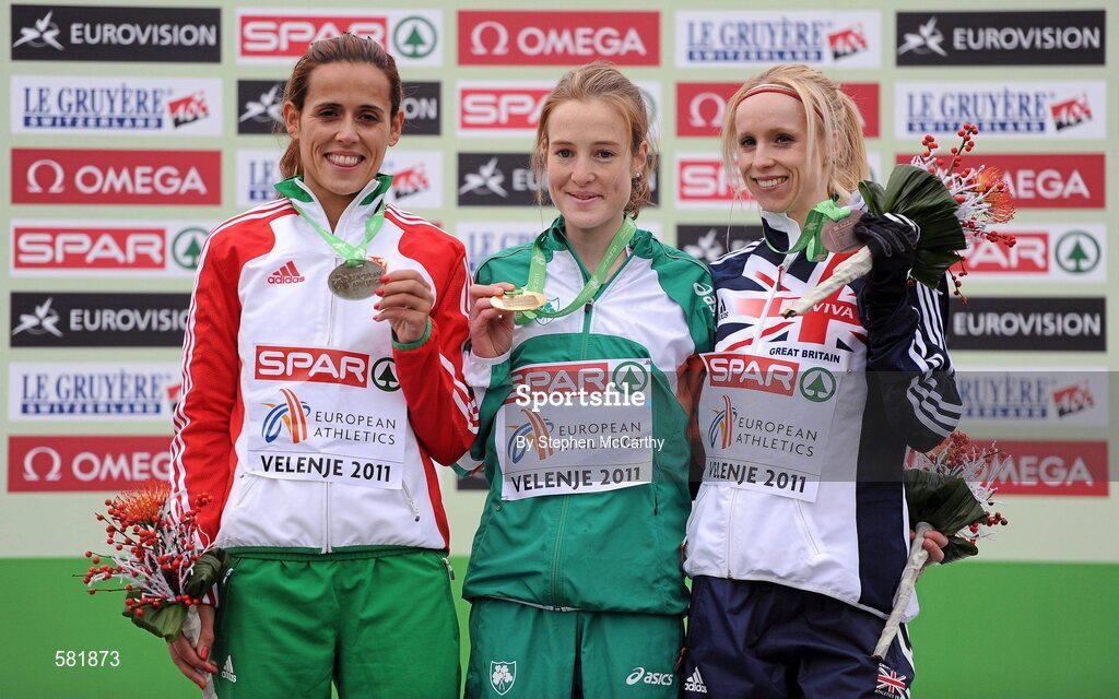 11 December 2011; Fionnuala Britton, Ireland, after being presented with her gold medal following her victory in the Senior Women's event, alongside second place Dulce Felix, Portugal, left, and third place Gemma Steel, Great Britain, right, at the 18th SPAR European Cross Country Championships 2011. Velenje, Slovenia. Picture credit: Stephen McCarthy / SPORTSFILE