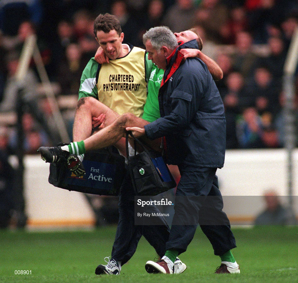 11th October 1998; Brian Stynes of Ireland, is carried off the field after picking up an injury by team physio Ronan Carolan, left, and team doctor Dr Jack Finn during the International Rules Series First Test match between Ireland and Australia at Croke Park in Dublin. Photo by Ray McManus/Sportsfile