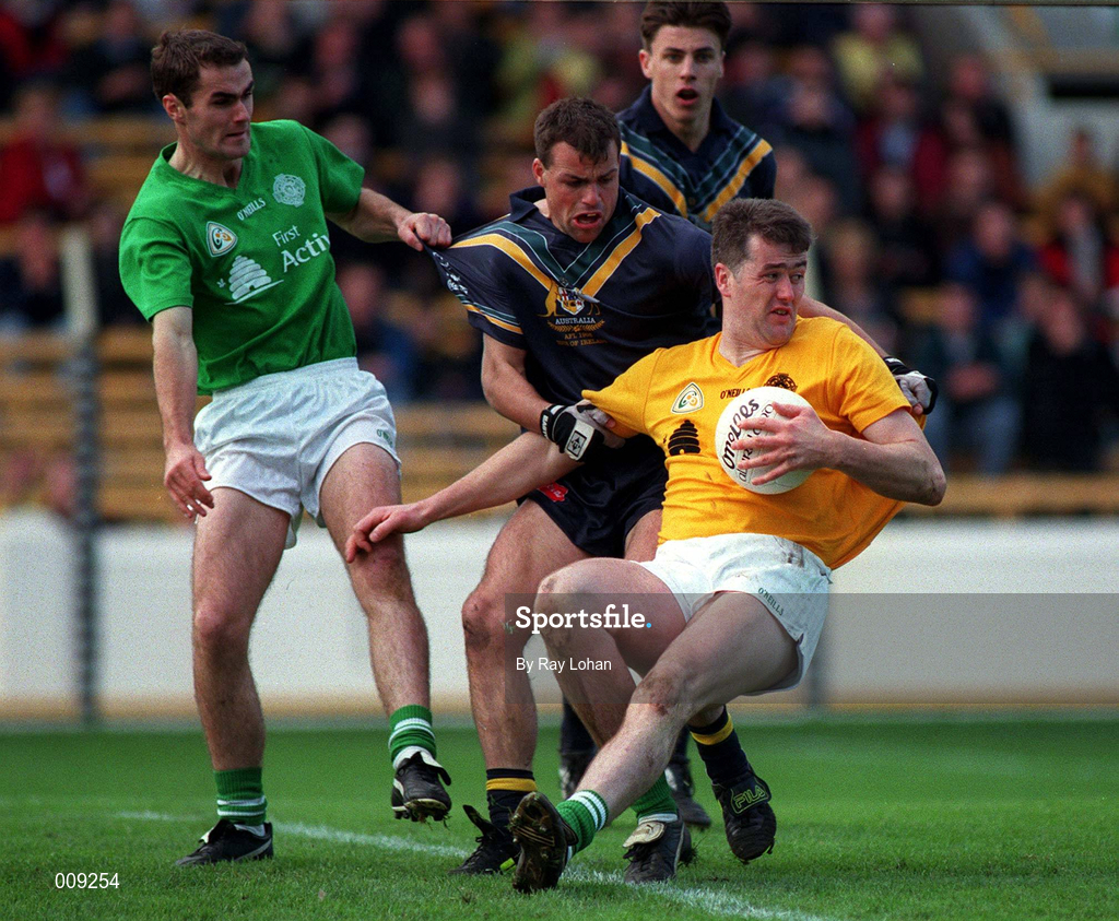 11th October 1998; Finbar McConnell of Ireland, supported by team-mate Seán Marty Lockhart, left, in action against Brad Johnson of Australia during the International Rules Series First Test match between Ireland and Australia at Croke Park in Dublin. Photo by Ray Lohan/Sportsfile