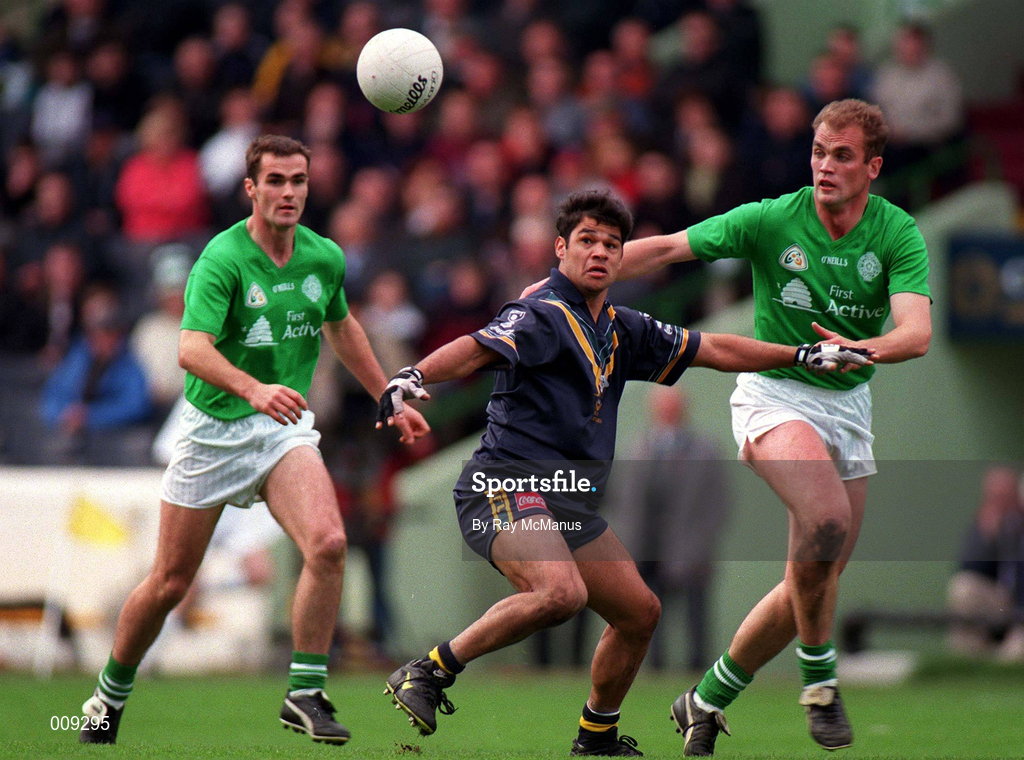 11 October 1998; Jeff Farmer of Australia in action against John McDermott, right, and Seán Marty Lockhart of Ireland during the International Rules Series First Test match between Ireland and Australia at Croke Park in Dublin. Photo by Ray McManus/Sportsfile