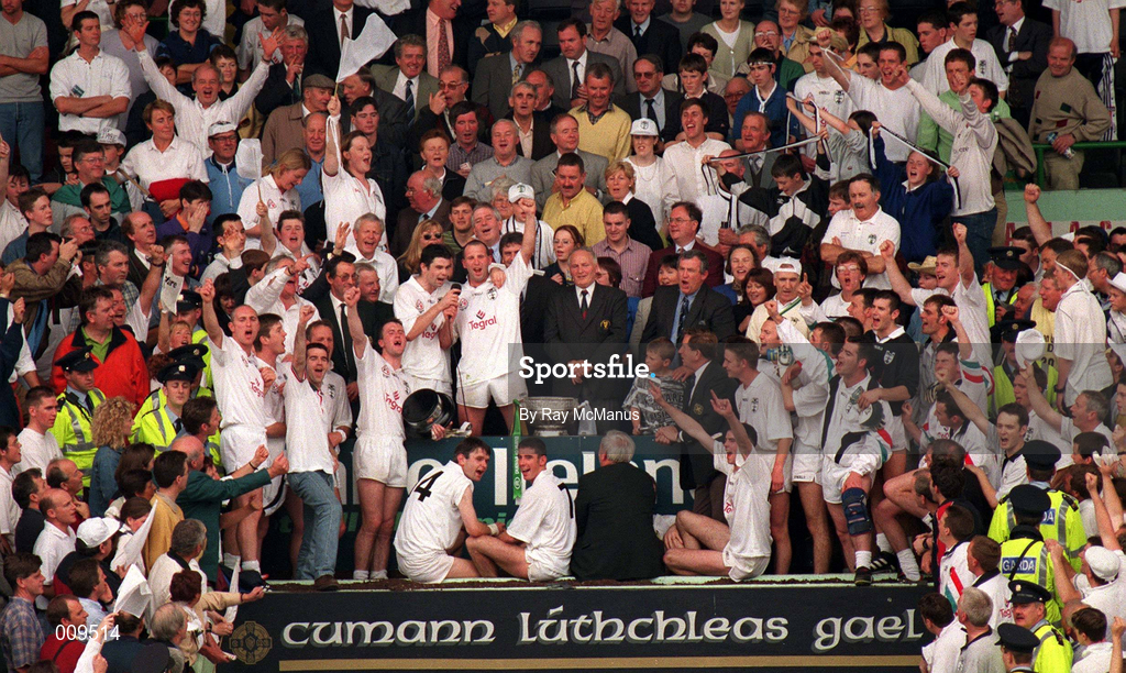 2 August 1998; Kildare captain Glenn Ryan looks on as team-mate Martin Lynch sings 'The Curragh of Kildare' from the presentation podium after the Bank of Ireland Leinster Senior Football Championship Final match between Kildare and Meath at Croke Park in Dublin. Photo by Ray McManus/Sportsfile