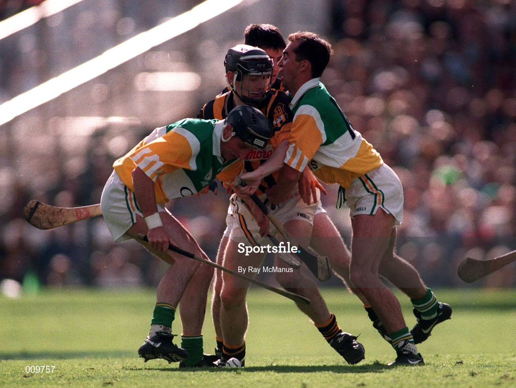 13 September 1998; Peter Barry of Kilkenny, supported by team-mate Philip Larkin, behind, in action against Billy Dooley, left, and Johnny Dooley of Offaly during the Guinness All-Ireland Senior Hurling Championship Final match between Kilkenny and Offaly at Croke Park in Dublin. Photo by Ray McManus/Sportsfile