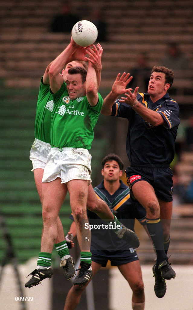 11th October 1998; Séamus Moynihan of Ireland, supported by team-mate John McDermott, behind, in action against Wayne Carey of Australia during the International Rules Series First Test match between Ireland and Australia at Croke Park in Dublin. Photo by Ray McManus/Sportsfile