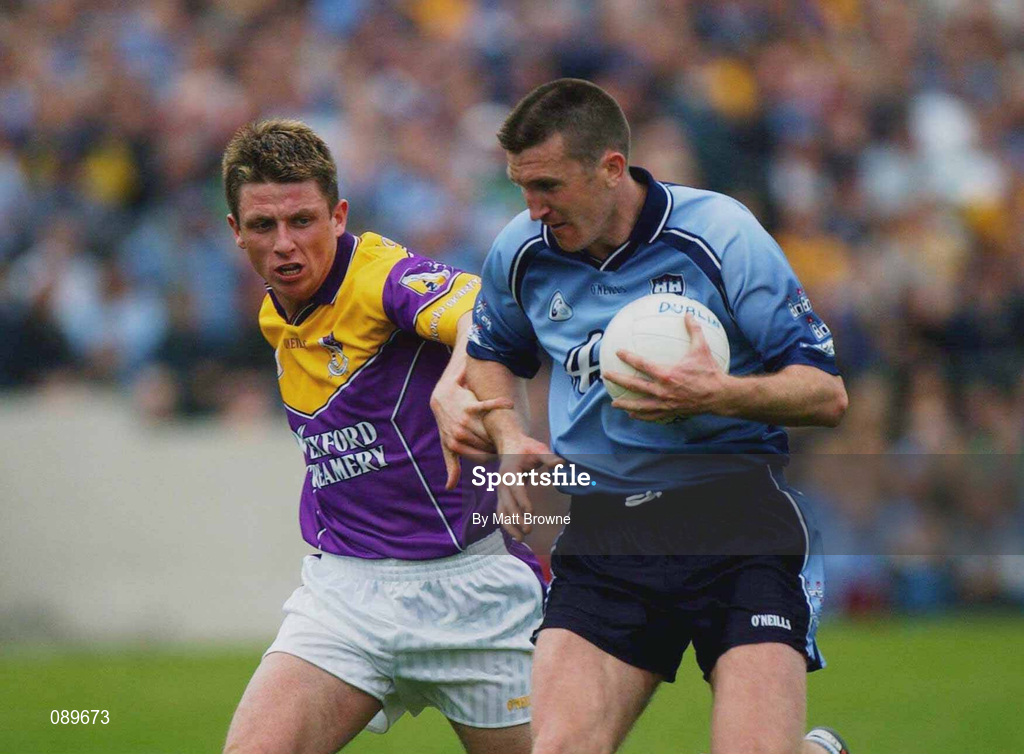 1 June 2002; Darren Homan of Dublin is tackled by Wexford's Diarmuid Kinsella during the Bank of Ireland Leinster Senior Football Championship Quarter-Final match between Wexford and Dublin at Dr. Cullen Park in Carlow. Photo by Matt Browne/Sportsfile