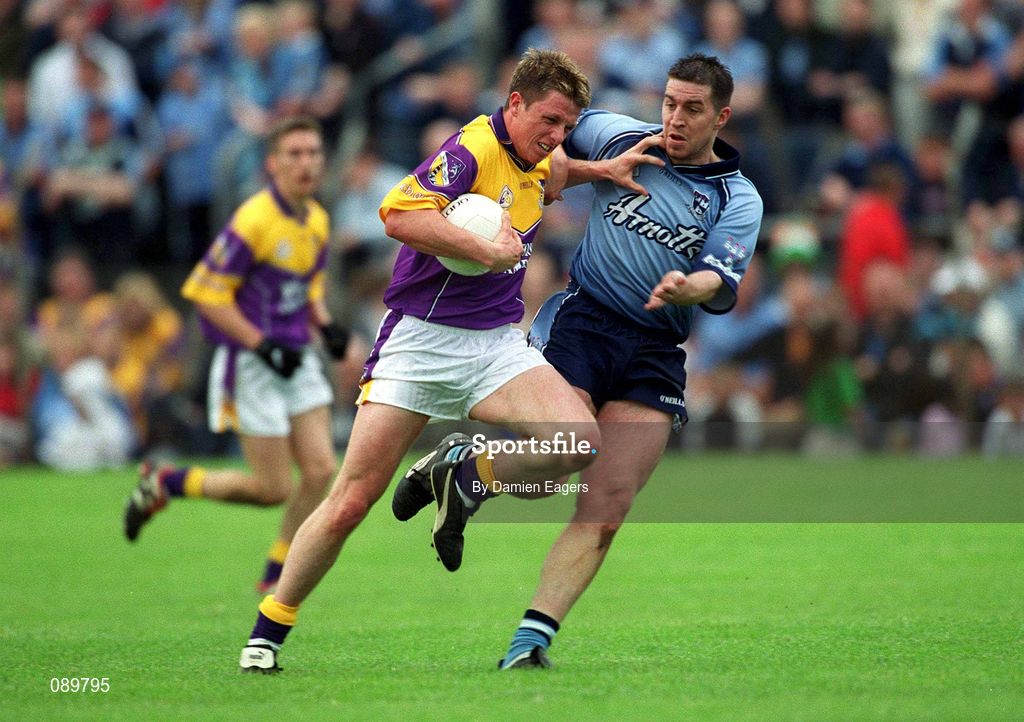 1 June 2002; Diarmuid Kinsella of Wexford in action against Jonathan Magee of Dublin during the Bank of Ireland Leinster Senior Football Championship Quarter-Final match between Wexford and Dublin at Dr. Cullen Park in Carlow. Photo by Damien Eagers/Sportsfile