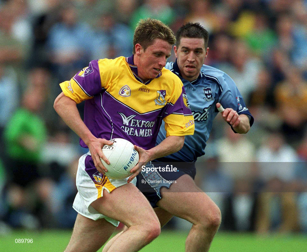 1 June 2002; Diarmuid Kinsella of Wexford in action against Jonathan Magee of Dublin during the Bank of Ireland Leinster Senior Football Championship Quarter-Final match between Wexford and Dublin at Dr. Cullen Park in Carlow. Photo by Damien Eagers/Sportsfile