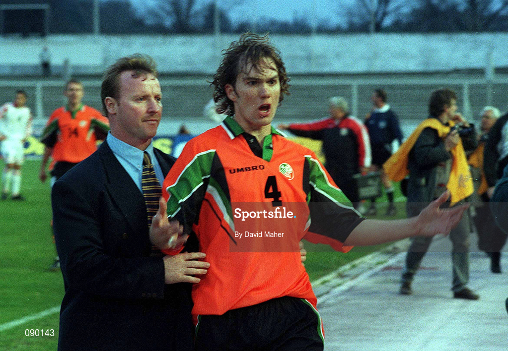 2 April 1997; Jason McAteer of Republic of Ireland is escorted from the field by Tony Hickey, team security, after being sent off during the FIFA World Cup 1998 Group 8 Qualifier match between FYR Macedonia and Republic of Ireland at the City Stadium in Skopje, FYR Macedonia. Photo by David Maher/Sportsfile