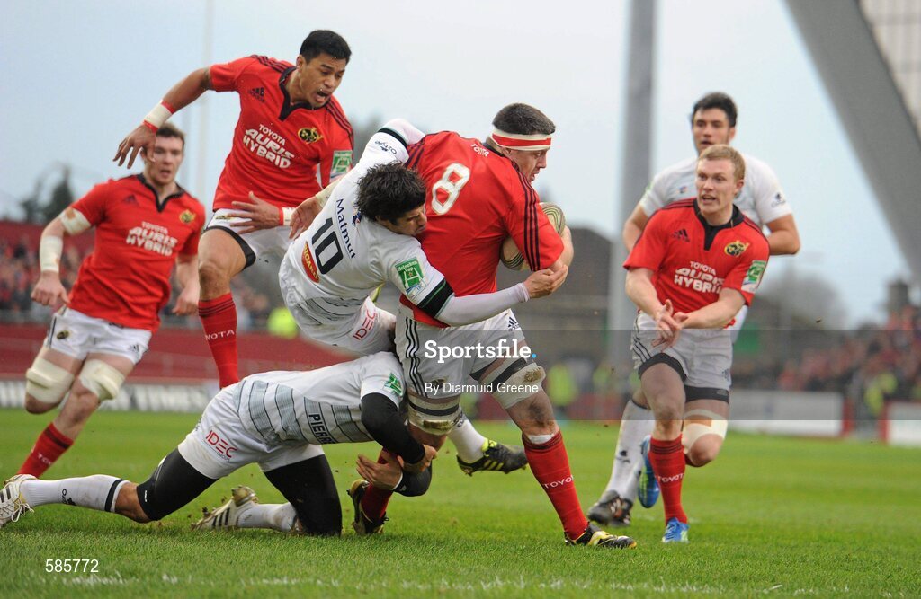 14 January 2012; James Coughlan, Munster, is tackled by Pierre Bernard, and Pierre-Gilles Lakafia, left, Castres Olympique. Heineken Cup, Pool 1, Round 5, Munster v Castres Olympique, Thomond Park, Limerick. Picture credit: Diarmuid Greene / SPORTSFILE