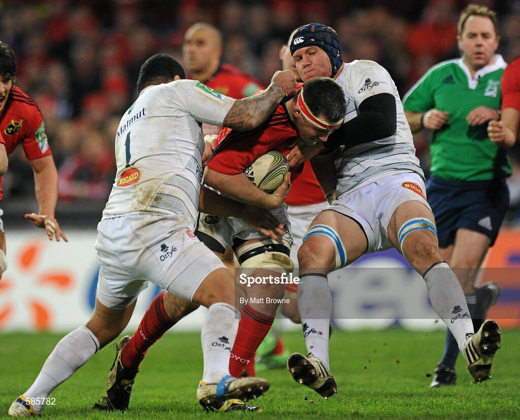 14 January 2012; James Coughlan, Munster, is tackled by Jannie Bornman, right, and Saimone Taumoepeau, Castres Olympique. Heineken Cup, Pool 1, Round 5, Munster v Castres Olympique, Thomond Park, Limerick. Picture credit: Matt Browne / SPORTSFILE