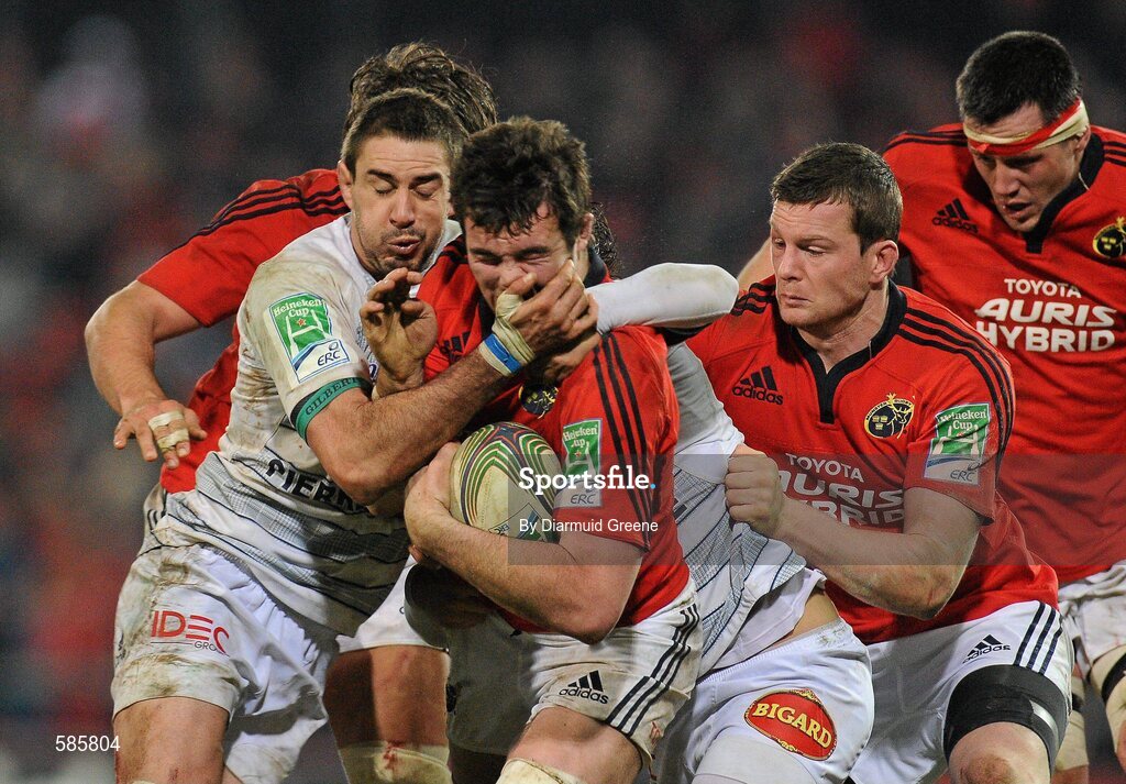 14 January 2012; Peter O'Mahony, Munster, is tackled by Yannick Caballero, left, and Pierre Bernard, Castres Olympique. Heineken Cup, Pool 1, Round 5, Munster v Castres Olympique, Thomond Park, Limerick. Picture credit: Diarmuid Greene / SPORTSFILE