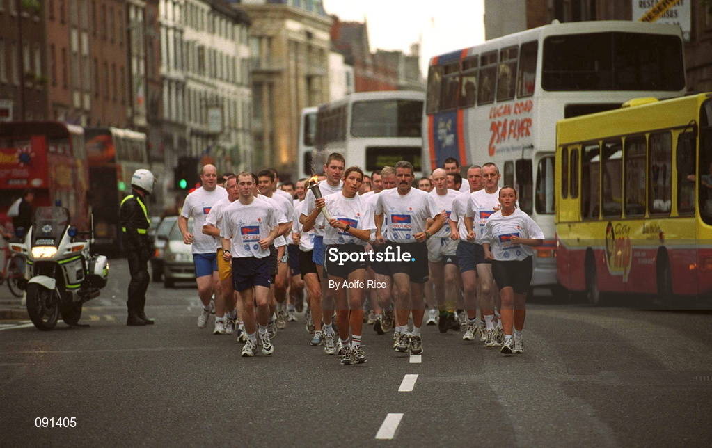 19 June 2002; Members of An Garda S’ochána and the Police Service of Northern Ireland carry the torch en route to the 2002 Special Olympics Ireland National Games Opening Ceremony at Parnell Park in Dublin. Photo by Aoife Rice/Sportsfile