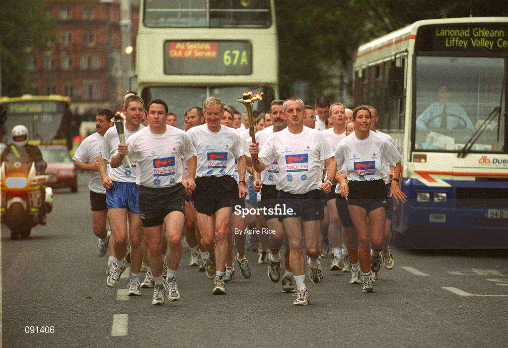 19 June 2002; Members of An Garda S’ochána and the Police Service of Northern Ireland carry the torch en route to the 2002 Special Olympics Ireland National Games Opening Ceremony at Parnell Park in Dublin. Photo by Aoife Rice/Sportsfile
