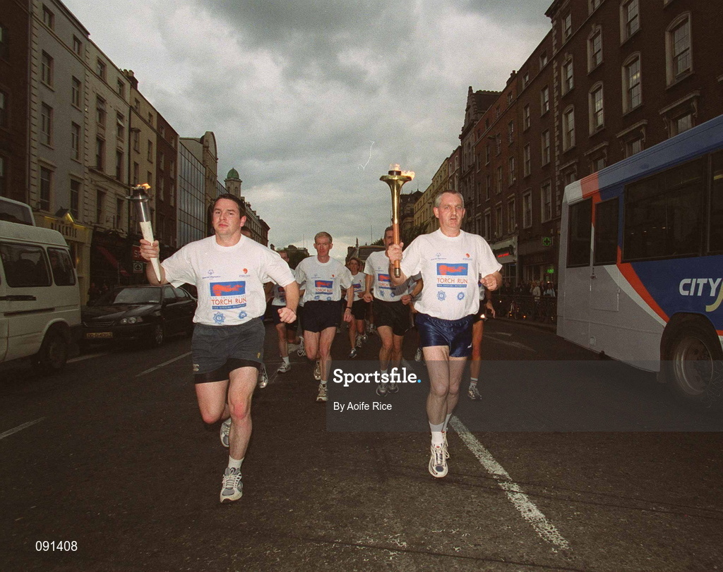 19 June 2002; Members of An Garda S’ochána and the Police Service of Northern Ireland carry the torch en route to the 2002 Special Olympics Ireland National Games Opening Ceremony at Parnell Park in Dublin. Photo by Aoife Rice/Sportsfile