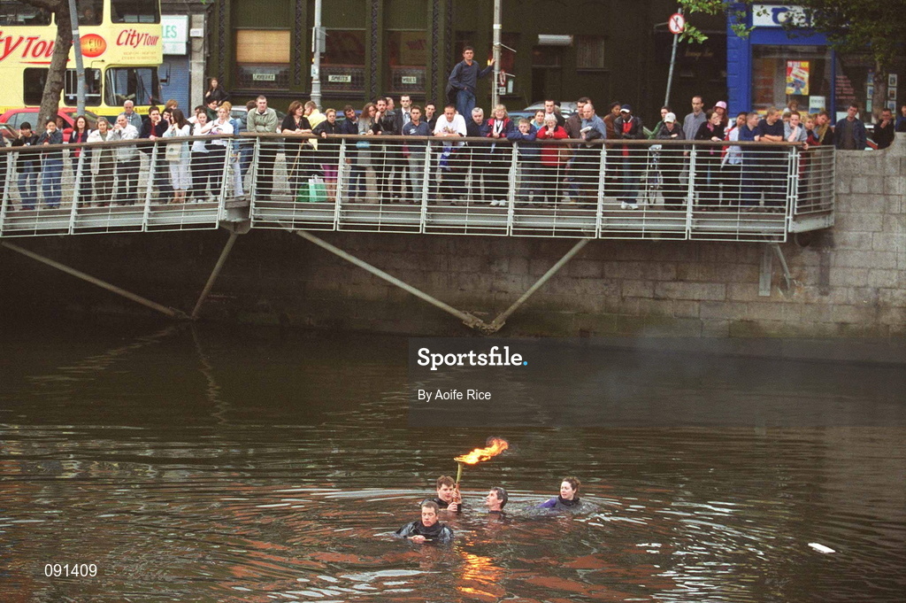 19 June 2002; Members of An Garda S’ochána and the Police Service of Northern Ireland carry the torch as they swim across the River Liffey en route to the 2002 Special Olympics Ireland National Games Opening Ceremony at Parnell Park in Dublin. Photo by Aoife Rice/Sportsfile