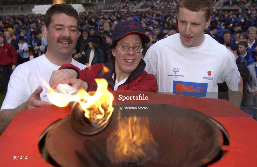 19 June 2002; Munster athlete Karina Houlihan lights the Special Olympics flame with the Olympics torch, with the help of Sgt Tim Craig of the Police Service of Northern Ireland, left, and Garda Fergal McDonagh of An Garda S’ochána during the 2002 Special Olympics Ireland National Games Opening Ceremony at Parnell Park in Dublin. Photo by Brendan Moran/Sportsfile