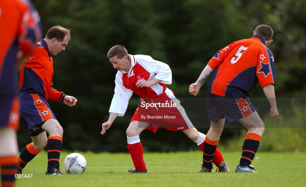 20 June 2002; Padraig O'Lone of Munster A in action against Leinster A's Declan Clifford, left, and Joe Kenny during their 2002 Special Olympics Ireland National Games 11-a-side soccer match at the UCD Bowl in Dublin. Photo by Brendan Moran/Sportsfile