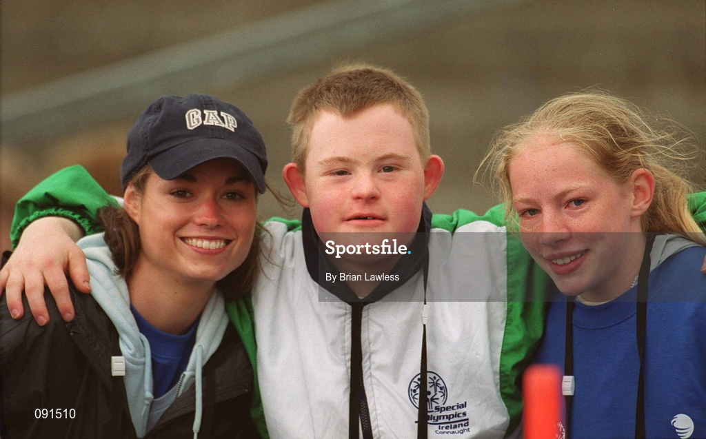 21 June 2002; Special Olympics athlete Brian Cavanagh, from Galway, with volunteer's Maria Murphy, left, and Fiona Clinton, after he had competed in the Long Jump event during the 2002 Special Olympics Ireland National Games at Morton Stadium in Santry, Dublin. Photo by Brian Lawless/Sportsfile