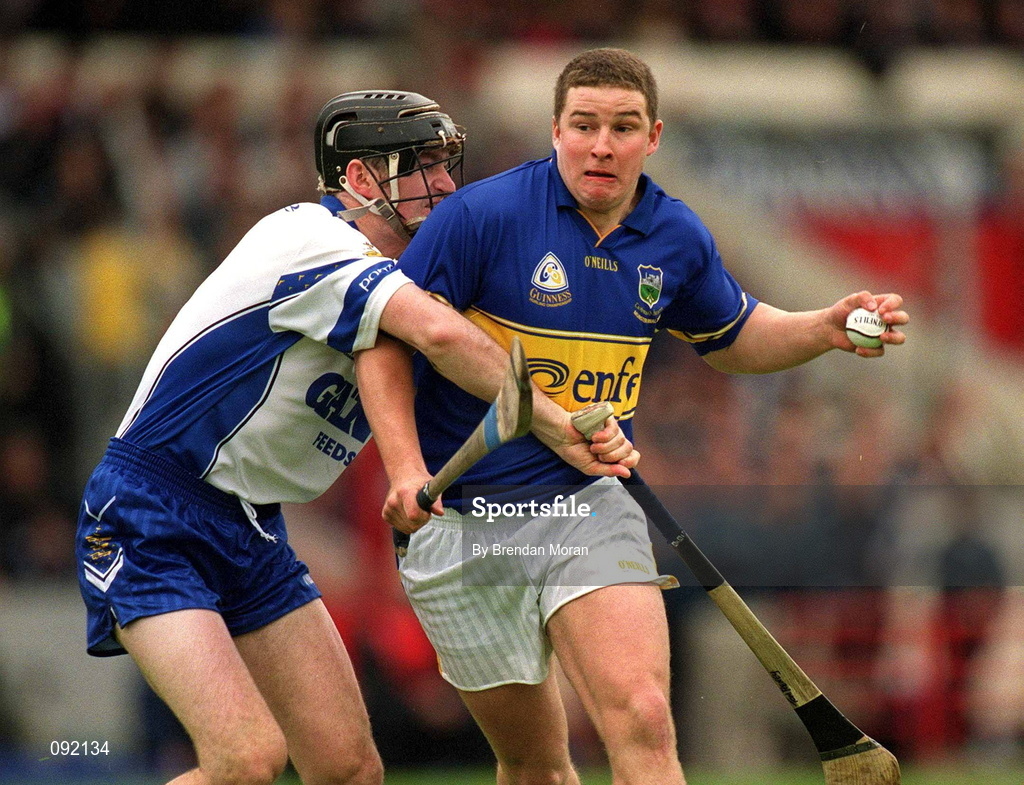 30 June 2002; John Carroll of Tipperary, in action against Waterford's Tom Feeney during the Guinness Munster Senior Hurling Championship Final match between Waterford and Tipperary at Páirc Uí Chaoimh in Cork. Photo by Brendan Moran/Sportsfile