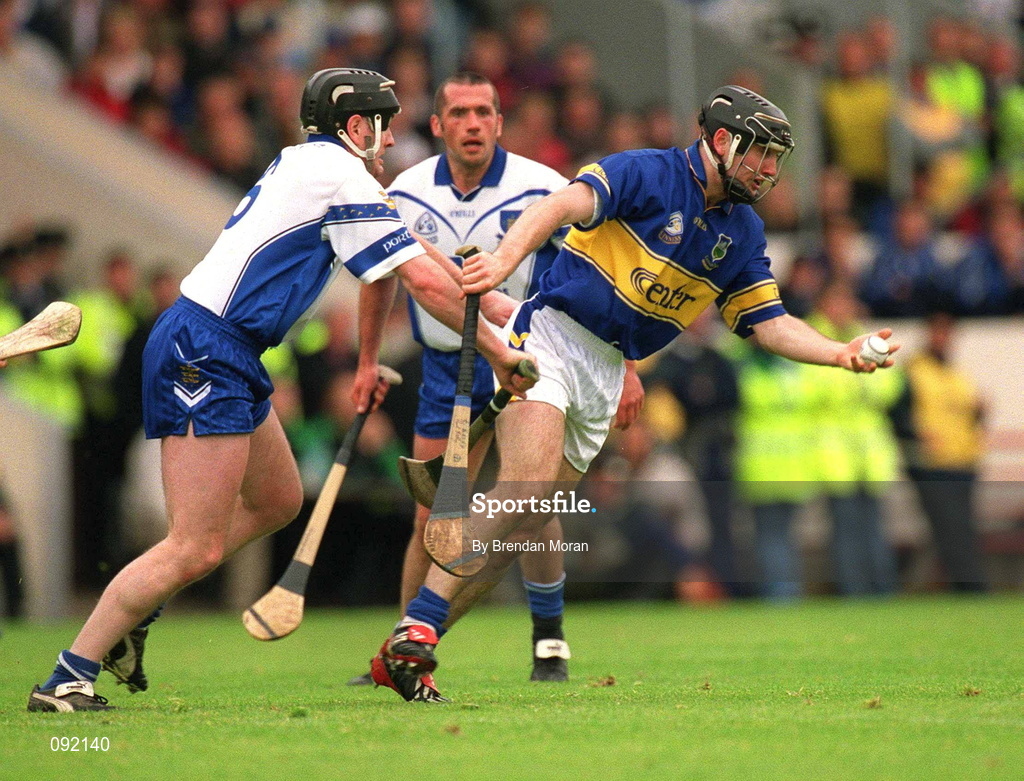 30 June 2002; Eoin Kelly of Tipperary in action against Waterford's Fergal Hartley during the Guinness Munster Senior Hurling Championship Final match between Waterford and Tipperary at Páirc Uí Chaoimh in Cork. Photo by Brendan Moran/Sportsfile