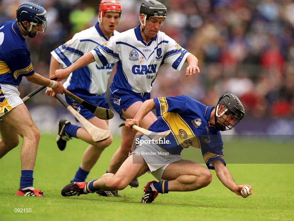 30 June 2002; Thomas Dunne of Tipperary in action against Waterford's Dave Bennett during the Guinness Munster Senior Hurling Championship Final match between Waterford and Tipperary at Páirc Uí Chaoimh in Cork. Photo by Brendan Moran/Sportsfile