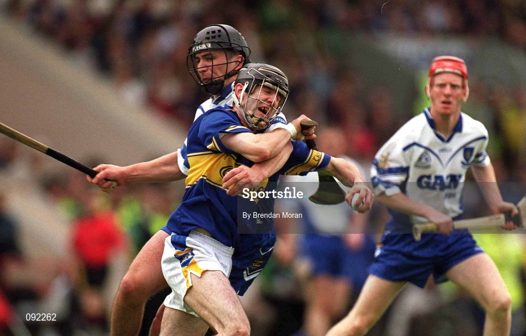 30 June 2002; Thomas Costello of Tipperary is tackled by Waterford's Seamus Prendergast during the Guinness Munster Senior Hurling Championship Final match between Waterford and Tipperary at Páirc Uí Chaoimh in Cork. Photo by Brendan Moran/Sportsfile