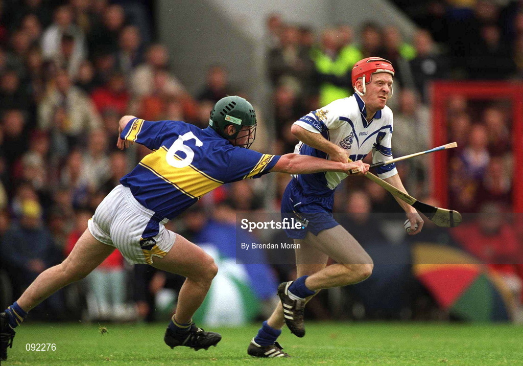 30 June 2002; John Mullane of Waterford is tackled by David Kennedy of Tipperary during the Guinness Munster Senior Hurling Championship Final match between Waterford and Tipperary at Páirc Uí Chaoimh in Cork. Photo by Brendan Moran/Sportsfile