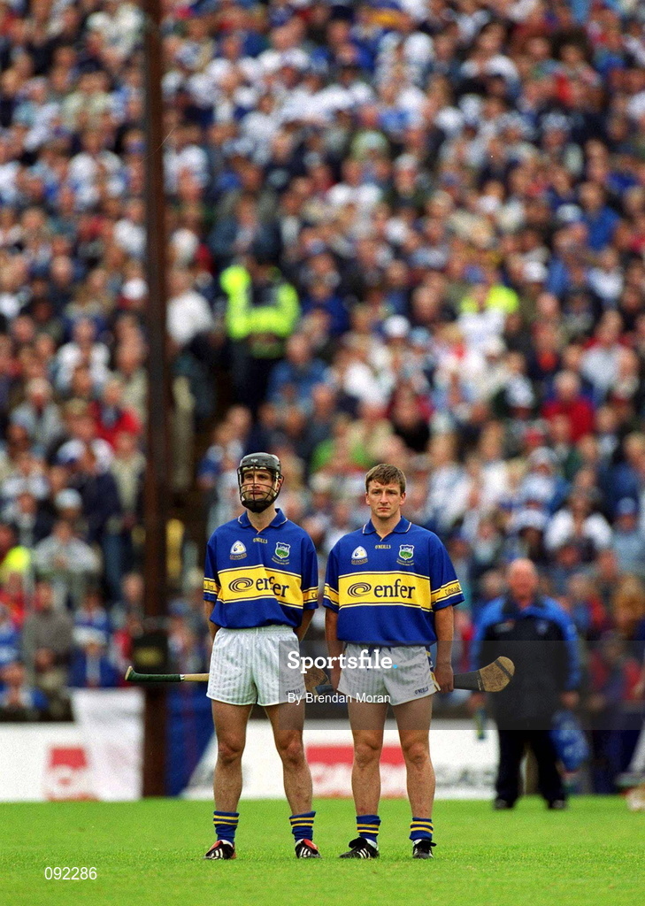 30 June 2002; Tipperary midfielders Thomas Dunne, left, and Noel Morris stand for the National Anthem during the Guinness Munster Senior Hurling Championship Final match between Waterford and Tipperary at Páirc Uí Chaoimh in Cork. Photo by Brendan Moran/Sportsfile