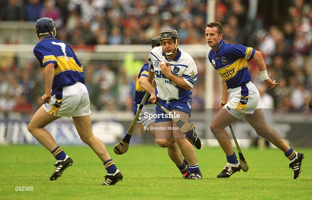 30 June 2002; Paul Flynn of Waterford in action against Tipperary's Paul Kelly, left, Thomas Dunne and Brian O'Meara during the Guinness Munster Senior Hurling Championship Final match between Waterford and Tipperary at Páirc Uí Chaoimh in Cork. Photo by Brendan Moran/Sportsfile