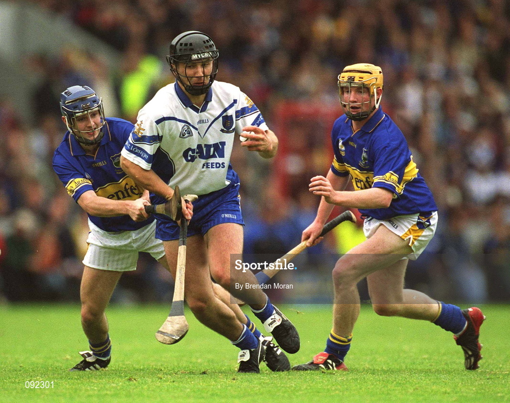 30 June 2002; Seamus Prendergast of Waterford in action against Tipperary's Paul Kelly, left, and Eamonn Corcoran during the Guinness Munster Senior Hurling Championship Final match between Waterford and Tipperary at Páirc Uí Chaoimh in Cork. Photo by Brendan Moran/Sportsfile