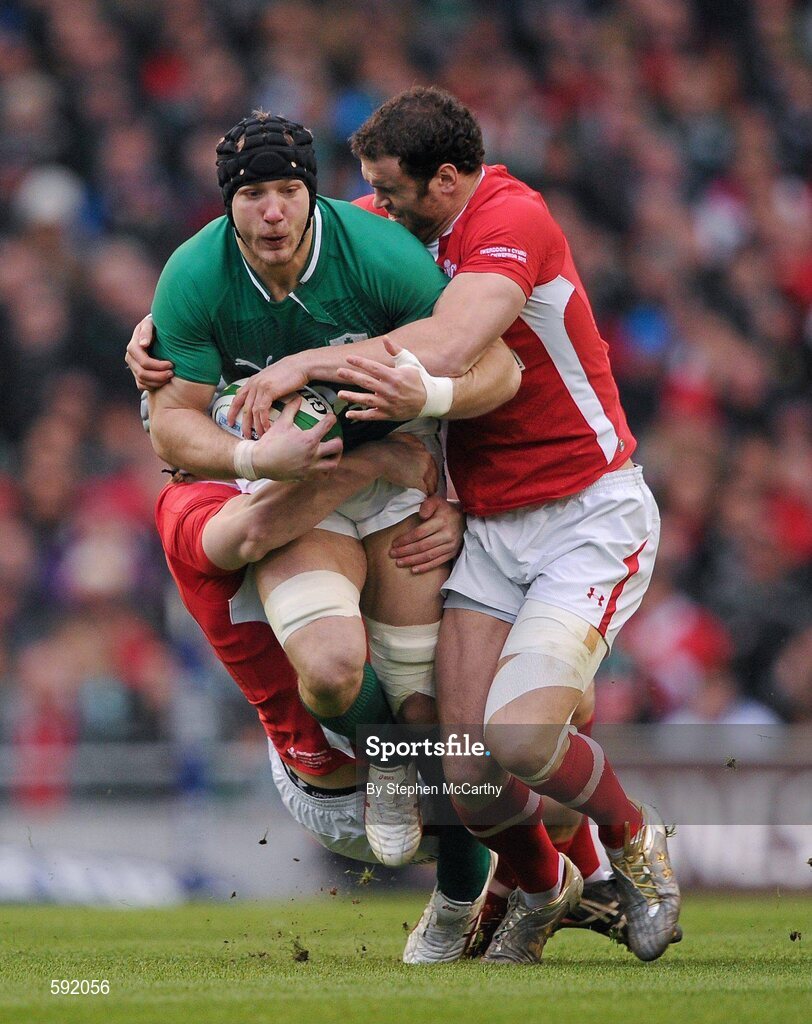 5 February 2012; Stephen Ferris, Ireland, is tackled by Jonathan Davies and Jamie Roberts, right, Wales. RBS Six Nations Rugby Championship, Ireland v Wales, Aviva Stadium, Lansdowne Road, Dublin. Picture credit: Stephen McCarthy / SPORTSFILE
