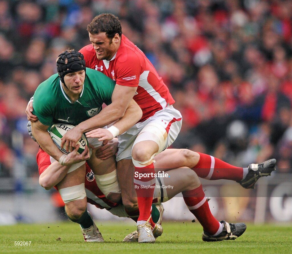 5 February 2012; Stephen Ferris, Ireland, is tackled by Jonathan Davies and Jamie Roberts, right, Wales. RBS Six Nations Rugby Championship, Ireland v Wales, Aviva Stadium, Lansdowne Road, Dublin. Picture credit: Stephen McCarthy / SPORTSFILE