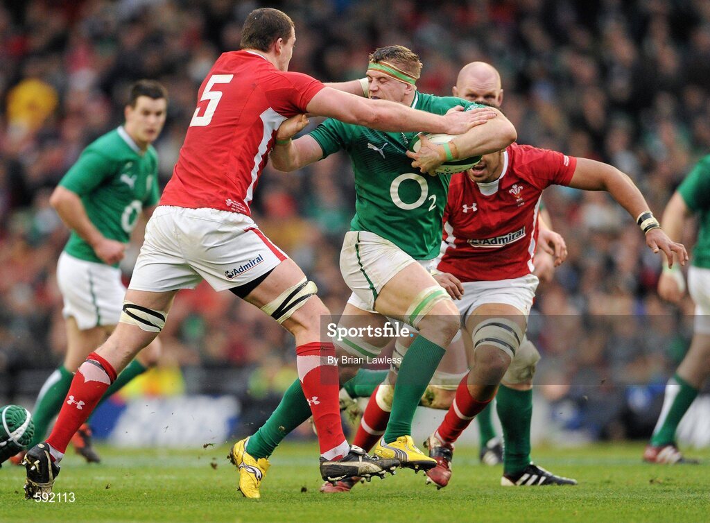 5 February 2012; Jamie Heaslip, Ireland, is tackled by Ian Evans, Wales. RBS Six Nations Rugby Championship, Ireland v Wales, Aviva Stadium, Lansdowne Road, Dublin. Picture credit: Brian Lawless / SPORTSFILE