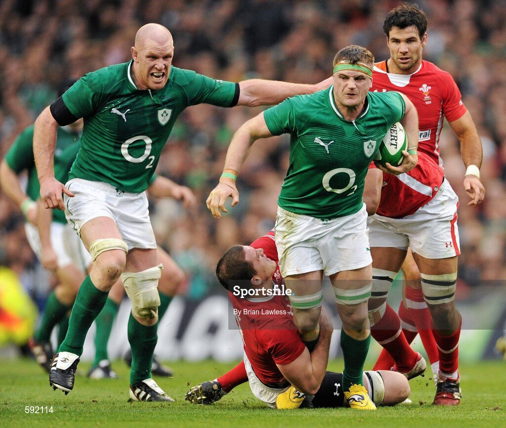 5 February 2012; Jamie Heaslip, Ireland, with support from team mate Paul O'Connell, is tackled by Ian Evans, left, and Toby Faletau, Wales. RBS Six Nations Rugby Championship, Ireland v Wales, Aviva Stadium, Lansdowne Road, Dublin. Picture credit: Brian Lawless / SPORTSFILE
