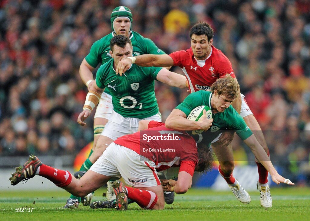 5 February 2012; Andrew Trimble, Ireland, is tackled by Rhys Gill, left, and Mike Phillips, Wales. RBS Six Nations Rugby Championship, Ireland v Wales, Aviva Stadium, Lansdowne Road, Dublin. Picture credit: Brian Lawless / SPORTSFILE