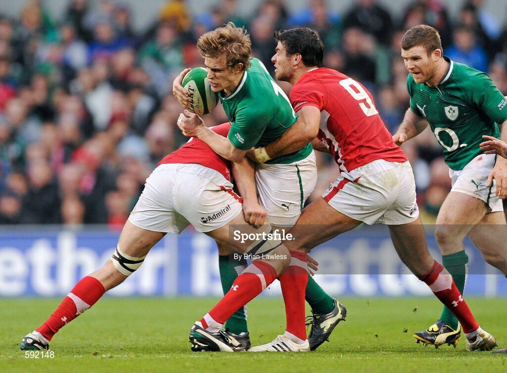 5 February 2012; Andrew Trimble, Ireland, is tackled by Ryan Jones, left, and Mike Phillips, Wales. RBS Six Nations Rugby Championship, Ireland v Wales, Aviva Stadium, Lansdowne Road, Dublin. Picture credit: Brian Lawless / SPORTSFILE