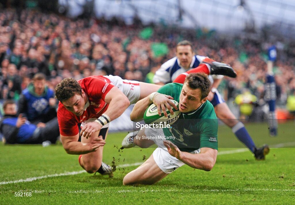 5 February 2012; Tommy Bowe, Ireland, on his way to scoring his side's second try, despite the attention of George North, Wales. RBS Six Nations Rugby Championship, Ireland v Wales, Aviva Stadium, Lansdowne Road, Dublin. Picture credit: Stephen McCarthy / SPORTSFILE