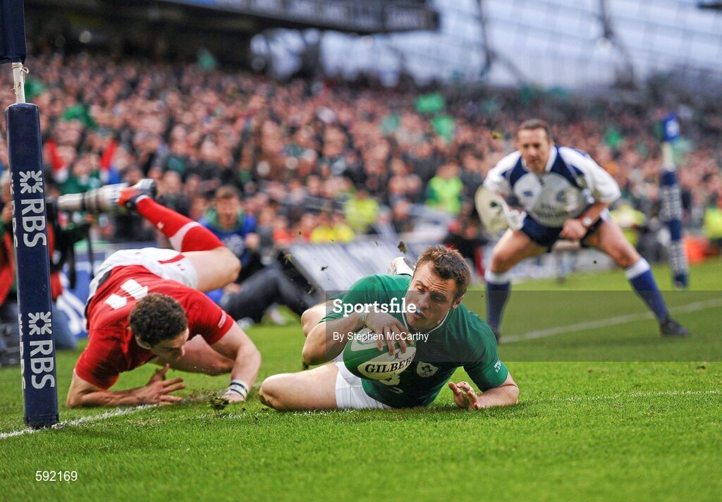 5 February 2012; Tommy Bowe, Ireland, goes over to score his side's second try, despite the attention of George North, Wales. RBS Six Nations Rugby Championship, Ireland v Wales, Aviva Stadium, Lansdowne Road, Dublin. Picture credit: Stephen McCarthy / SPORTSFILE