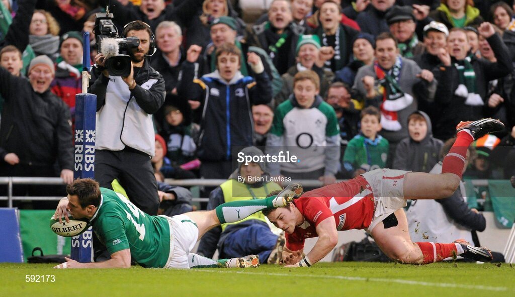 5 February 2012; Tommy Bowe, Ireland, goes over to score his side's second try, despite the attention of George North, Wales. RBS Six Nations Rugby Championship, Ireland v Wales, Aviva Stadium, Lansdowne Road, Dublin. Picture credit: Brian Lawless / SPORTSFILE